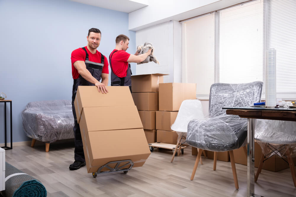 Movers Unloading Furniture At New Home
